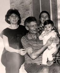 Vintage portrait of grandfather, grandmother, daughter and granddaughter. Three generations. Joy on faces. Retro photo 1995
