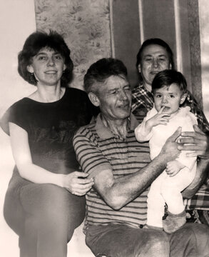 Vintage portrait of grandfather, grandmother, daughter and granddaughter. Three generations. Joy on faces. Retro photo 1995