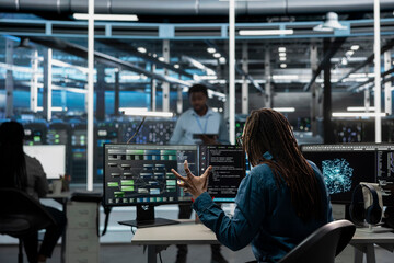 Data center admin raging, upset by errors while using AI visualization to oversee automated tasks. Mad server hub expert annoyed by glitches while modifying systems based on data analytics graphs