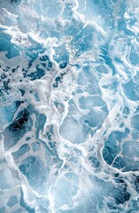 Naklejka premium A dramatic, close-up shot of turbulent ocean foam, showcasing intense blue and white textures, creating a dynamic and captivating visual.