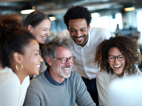 A multicultural team collaborating in a modern office, happy expressions, different ethnicities and body types, natural light, candid and inclusive business scene Diverse group of coworkers laughing 