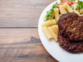 Meal with two tasty burgers, pasta and fresh salad and no sauce. Diet dinner for people with high blood sugar. Healthy food.
