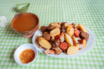 Colombian Platter with Guarapo and Ají on Green Checkered Tablecloth
