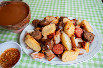 Close-Up of Colombian Picada with Chorizo, Arepa, and Pork Belly