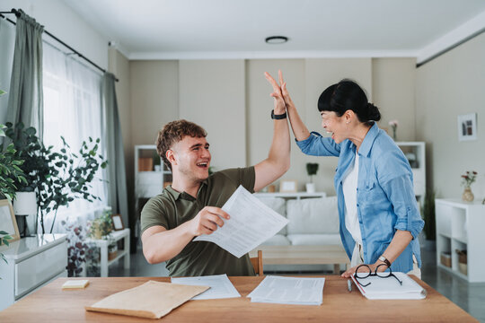 Happy student and teacher giving high five after successful exam correction