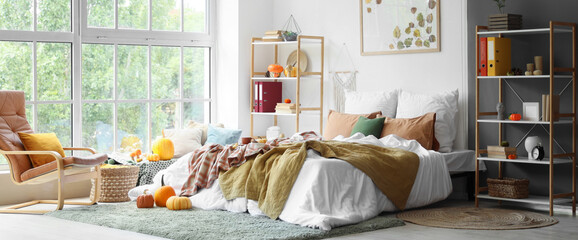 Interior of bedroom with shelf units and pumpkins