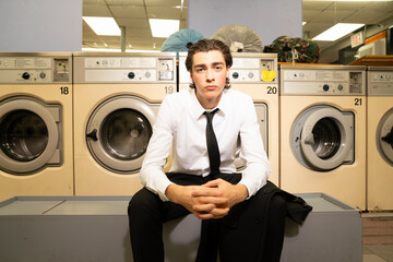 business man hangs out in laundromat
