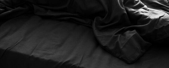Black linen on bed in bedroom