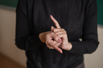 Woman showing the word translator in Russian sign language. 