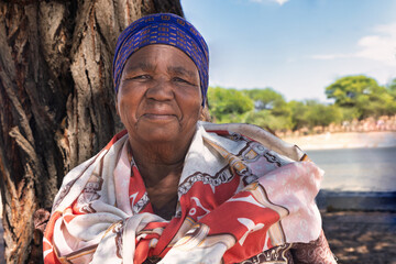 africa village, head and shoulders single elderly african woman, outdoors near a tree by the road © poco_bw