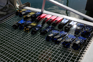 row of snorkeling flippers on boat
