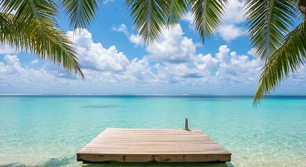 Wooden pier extending into turquoise ocean water under a blue sky with clouds dock jetty