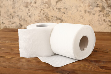Rolls of toilet paper on wooden table
