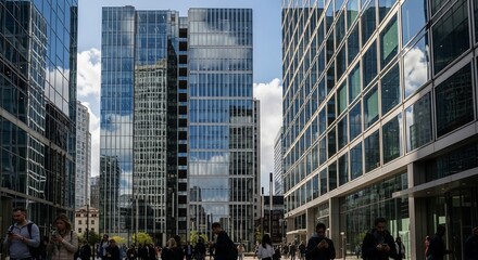 Obraz premium Urban Geometry: A captivating view of modern architecture and glass facades, highlighting intricate design, reflective surfaces, and the bustling city life below.