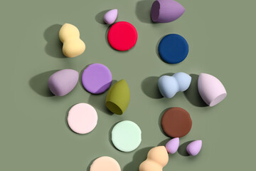 Different makeup sponges on green background