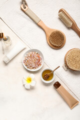 Composition with spa supplies and cosmetics on light background