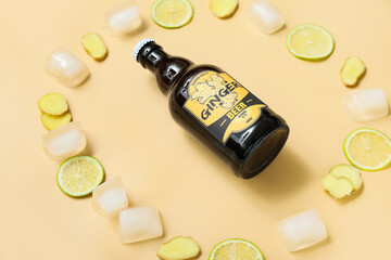 Composition with bottle of fresh ginger beer, lime slices and ice cubes on beige background, closeup