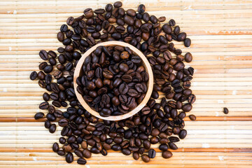 flat lay of coffee beans on a bamboo mat background