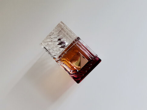 Textured glass perfume bottle isolated on white background from a high angle view