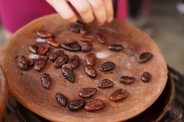 Traditional Mayan chocolate making in Guatemala with cacao beans and comal plate