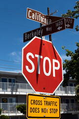 Photo of the street signs at the intersection of Berkeley Way & California Street in Berkeley, California &mdash; two metal street blades mounted on a pole, shown from a low/angled perspective against sky.