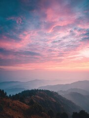 Obraz premium Stunning Sunset Over Rolling Hills With Vibrant Pink and Blue Sky in the Mountains at Dusk