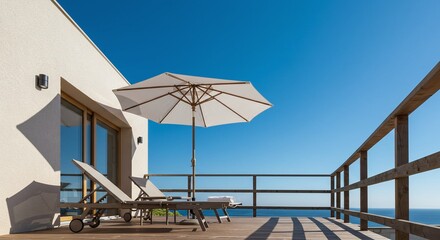 Fototapeta premium Serene coastal escape concept with a sun-drenched wooden deck, comfortable loungers, and an umbrella with a stunning ocean view on a sunny day.