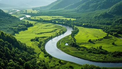 River meandering through lush green valley, mountain backdrop, aerial view, nature tourism