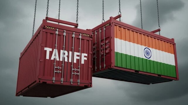 Two shipping containers suspended by chains one with tariff text and one with the indian flag on it