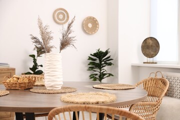 Stylish table with chairs and decor in dining room. Interior design