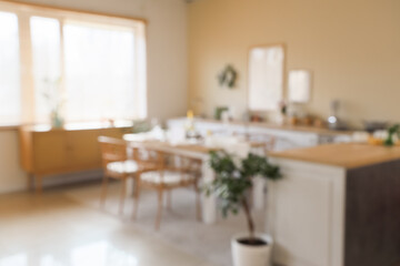 Blurred view of kitchen decorated for Easter with dining table and counters