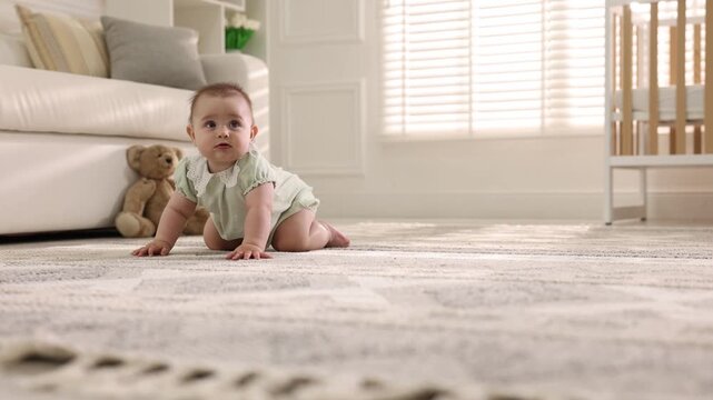 Cute little baby crawling on floor at home