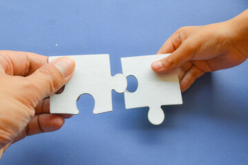 hand holding puzzle piece