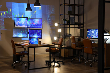 Interior of dark trader's office with desks and glowing lamps