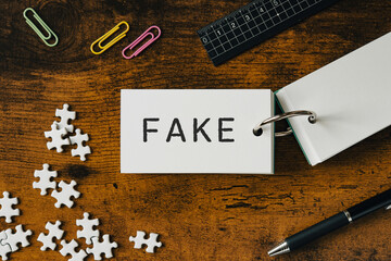 There is word card with the word FAKE. It is as an eye-catching image.