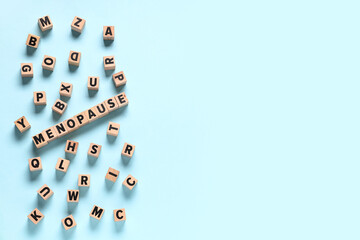 Cubes with word MENOPAUSE and letters on blue background