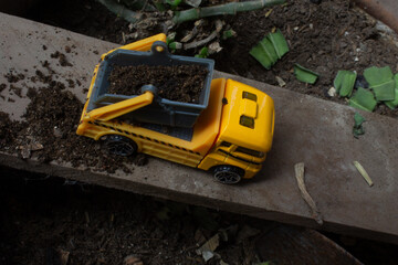 Fototapeta premium Heavy construction equipment working on a dirt road. Excavator and bulldozer move soil and sand at an industrial site for building and excavation work.