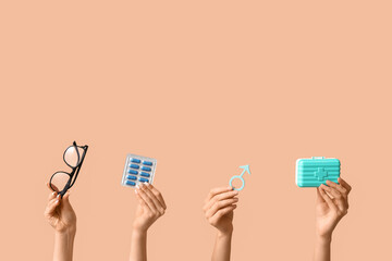 Female hands with symbol of man, pills and eyeglasses on beige background. Prostate Cancer...