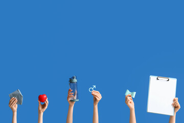 Female hands with symbol of man, clipboard and accessories on blue background. Prostate Cancer...