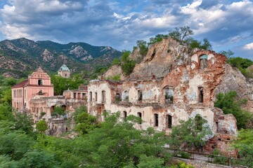 Fototapeta premium Ruined building complex nestled against a hillside