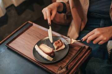 Woman eating tamako pork sandwich for morning breakfast. Japanese food.