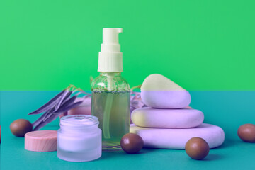 Composition with natural cosmetic products, spa stones and green olives on color background