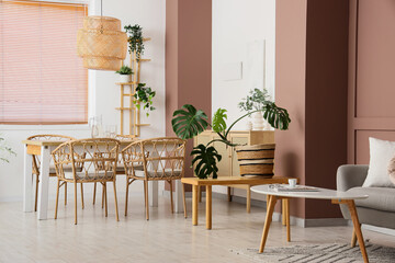 Interior of stylish living room with grey sofa and dining table