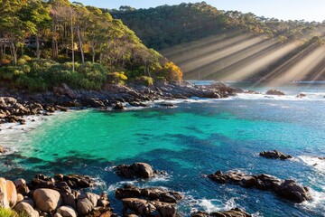 Coastal cove bathed in sunlight, turquoise water, rocky shore, lush hillside