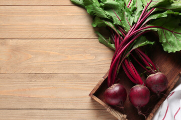 Tray with fresh beetroots on wooden background