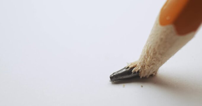 Close up of a yellow pencil with the graphite tip cracking under pressure. Problem of a pencil lead breaking symbolizing a stress or crisis at work or school, frustration, or a simple mistake.