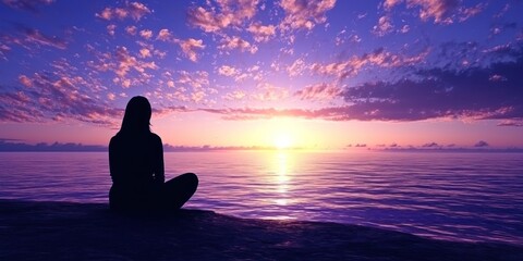 Fototapeta premium A beachside silhouette of someone peacefully watching the sun rise over the ocean