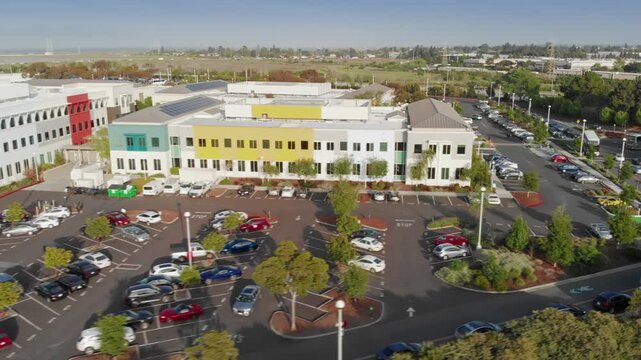 Aerial view of the Facebook Meta headquarters. Shows the office building, parking lot, and surrounding wetlands. Menlo Park, California, USA. 