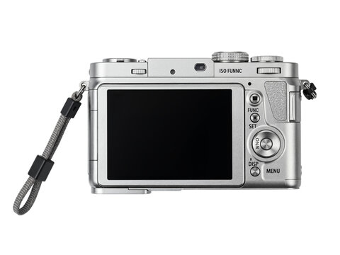 Rear view of a modern silver digital compact camera with a black screen and wrist strap isolated on transparent background
