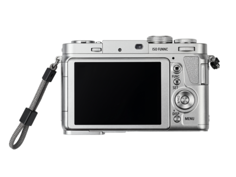 Rear view of a modern silver digital compact camera with a black screen and wrist strap isolated on transparent background